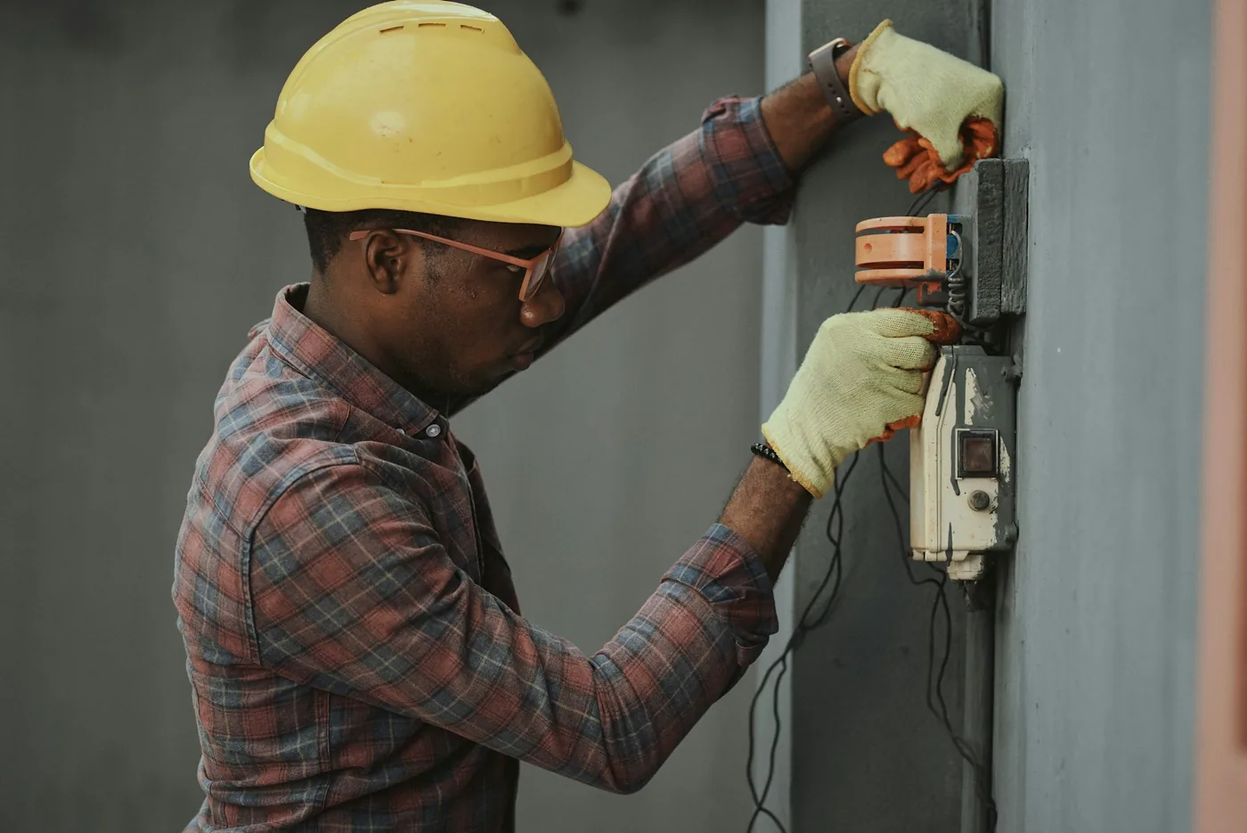 Electrician carefully inspecting an electrical installation