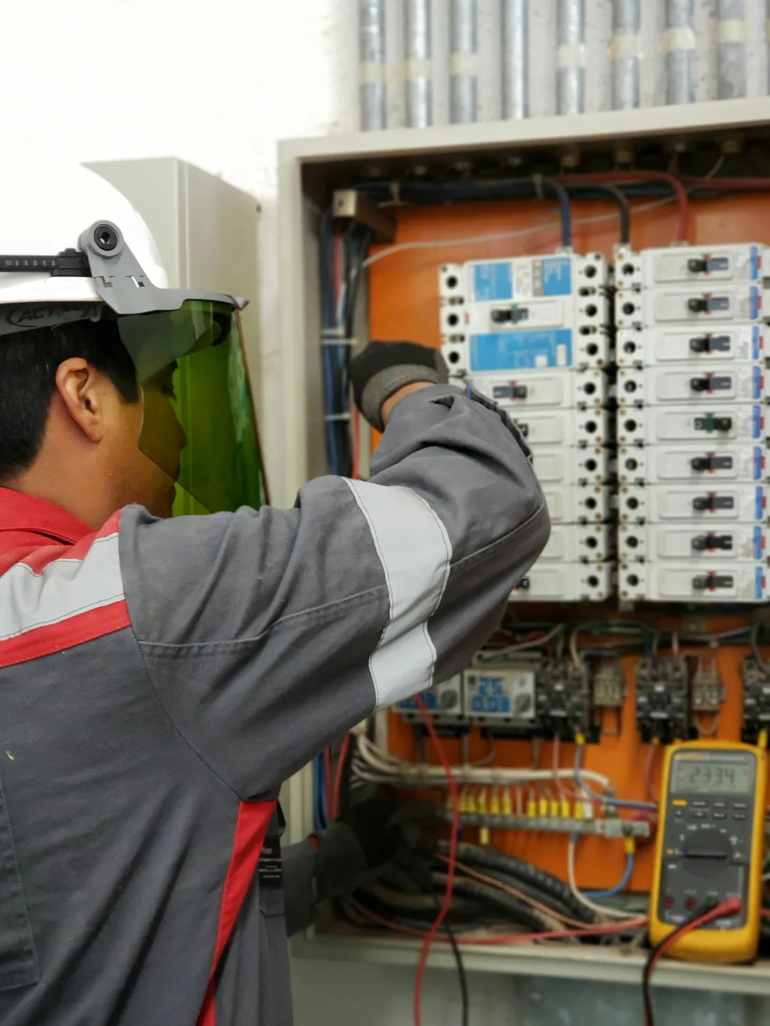 Detailed electrical panel work with protective equipment